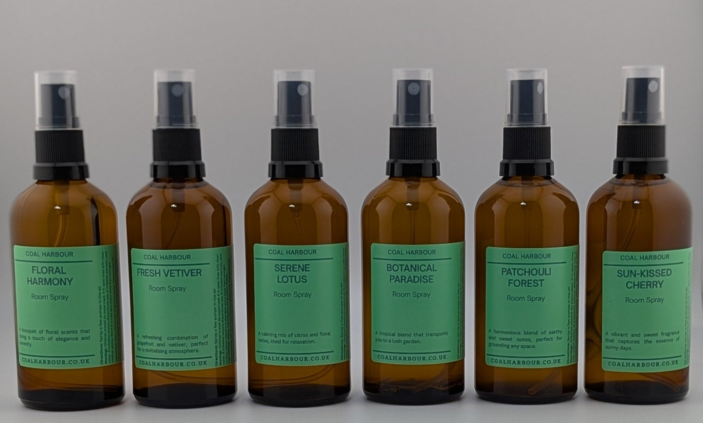 Row of brown bottles with green labels on a white background