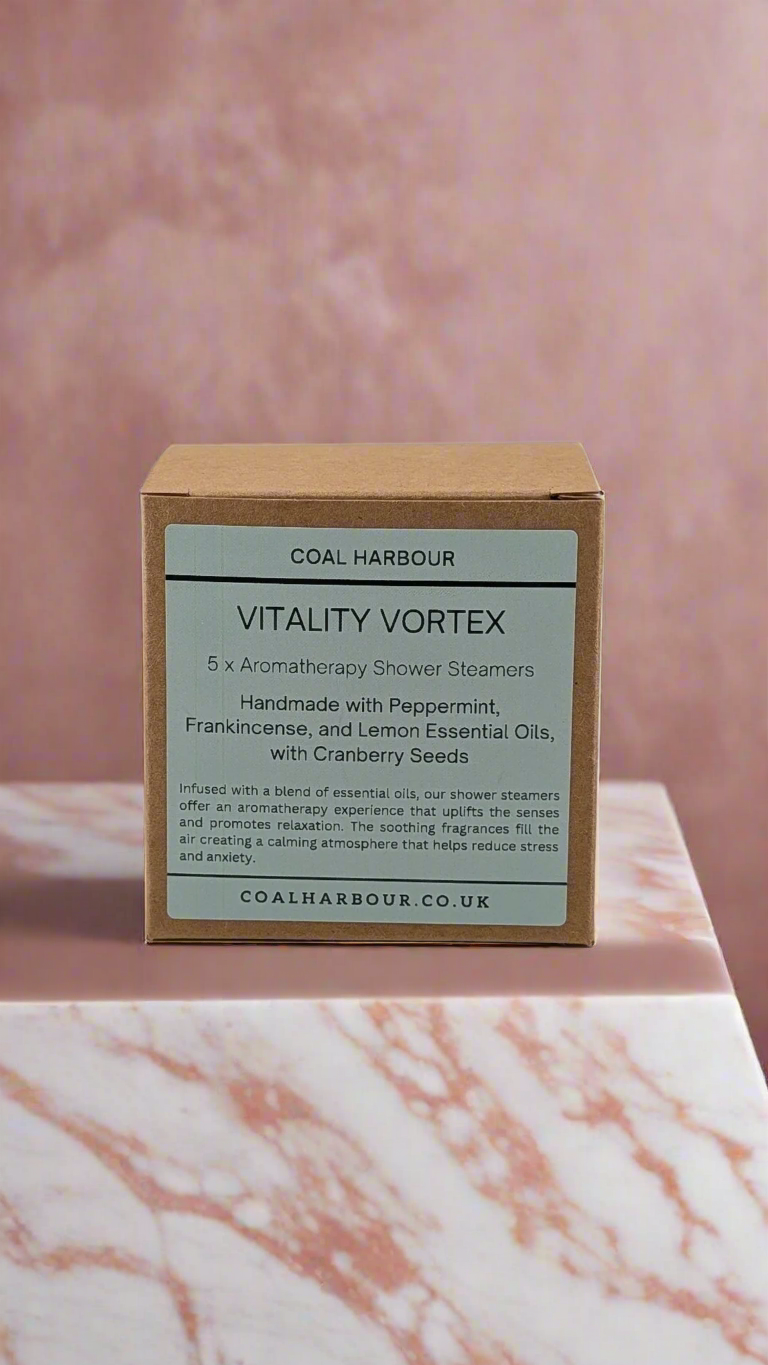 Box of Coal Harbour Vitality Vortex shower steamers on a marble surface with a pinkish-brown background