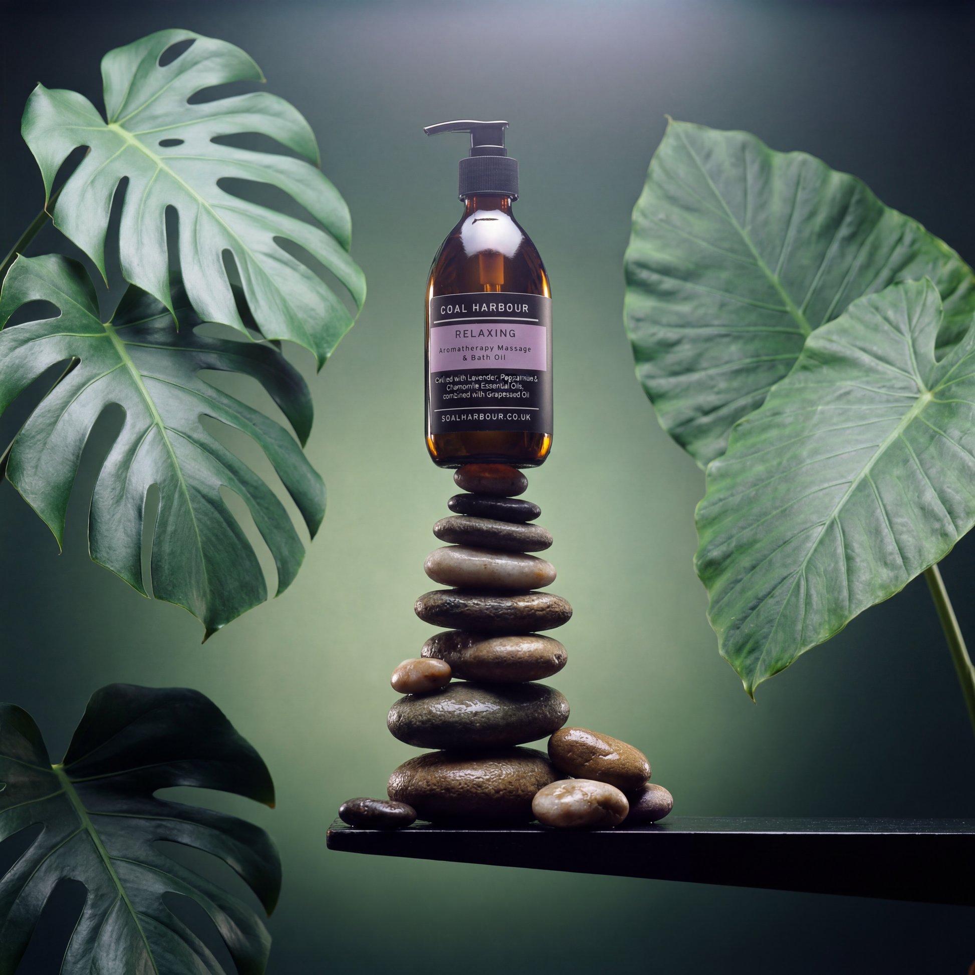 Bottle of Coal Harbour bath oil on a stack of stones with green leaves in the background