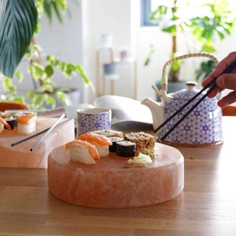 Round Himalayan salt cooking board with sushi teapot in blue and chopsticks