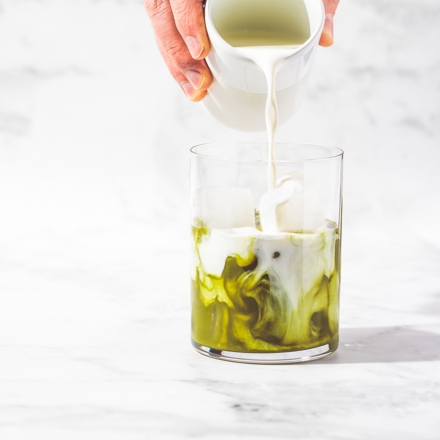 Matcha Culinary organic artisan tea being mixed with milk in a glass