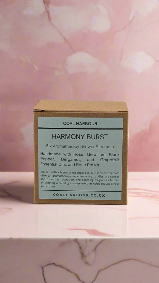 Box of Coal Harbour Harmony Burst shower steamers on a pink floral background