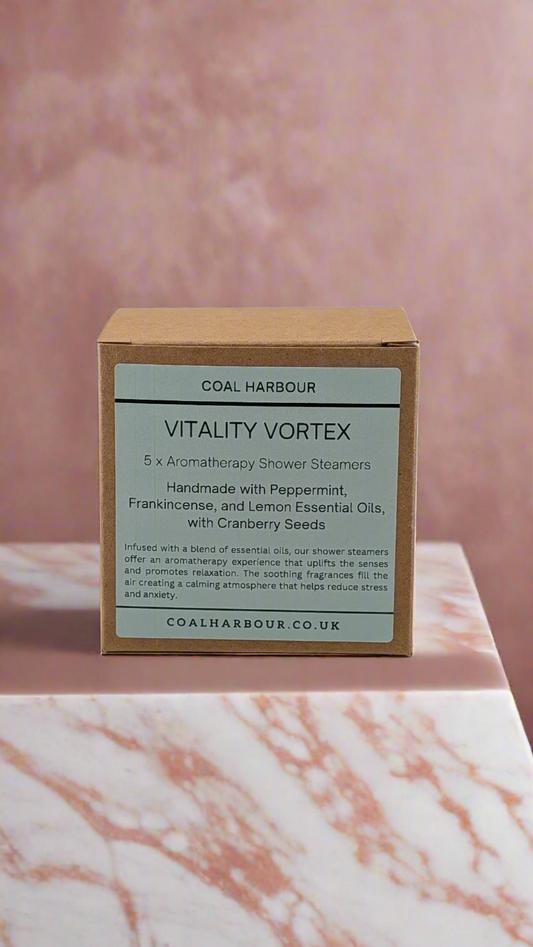 Box of Coal Harbour Vitality Vortex shower steamers on a marble surface with a pinkish-brown background